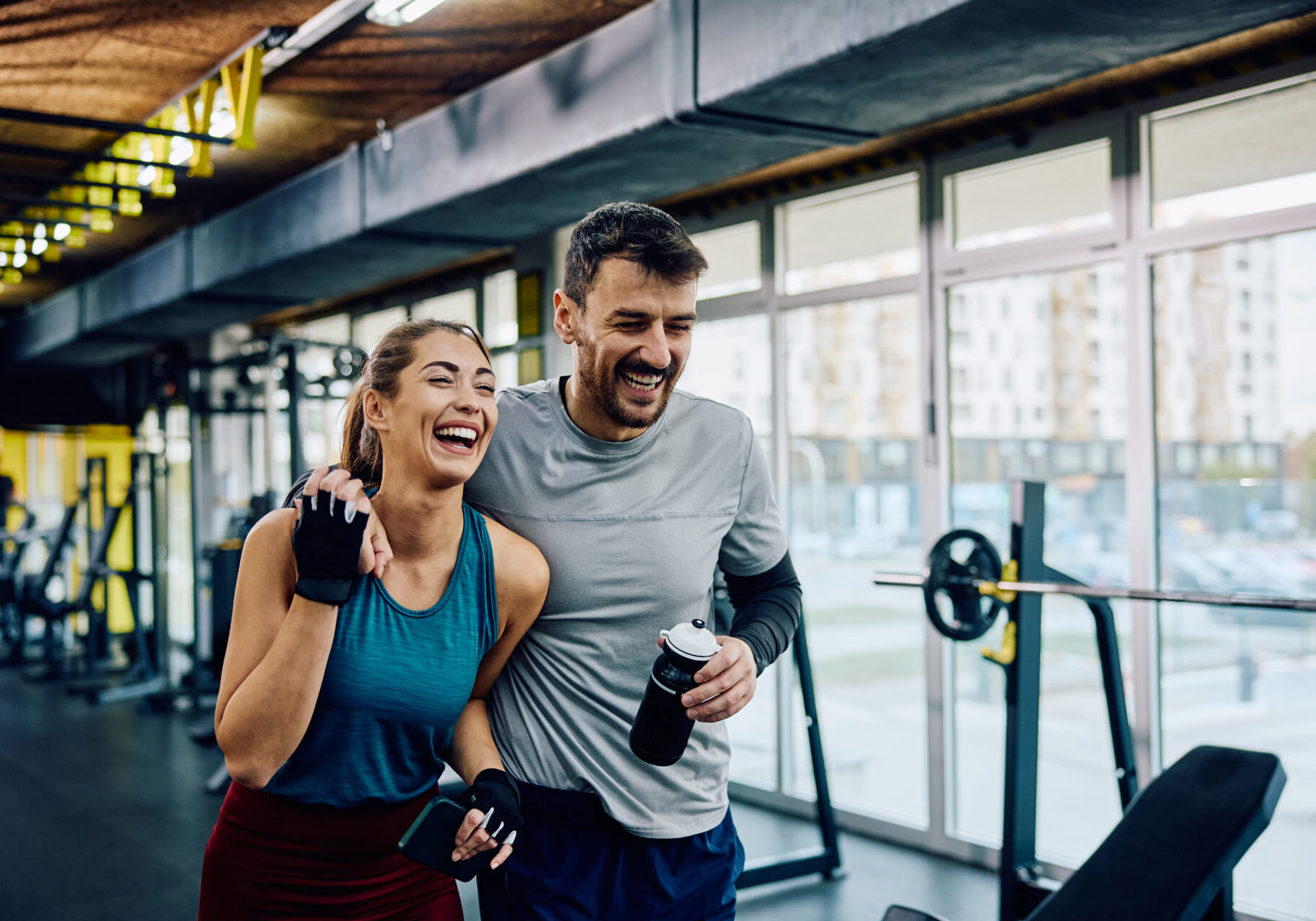 Smiling couple workout at the gym.