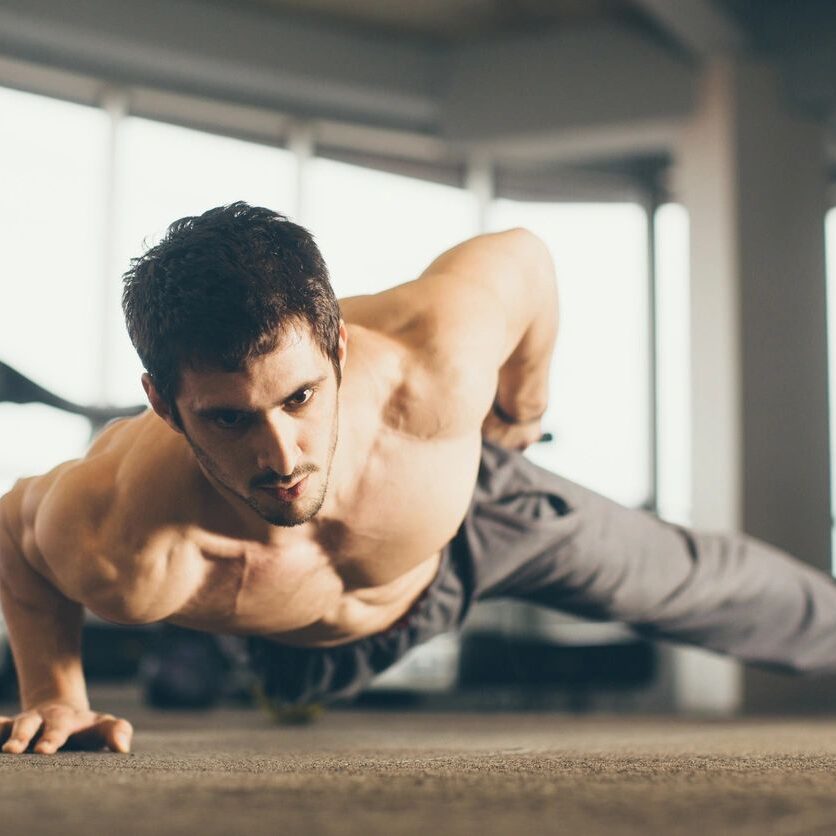 A man doing a push up in the gym